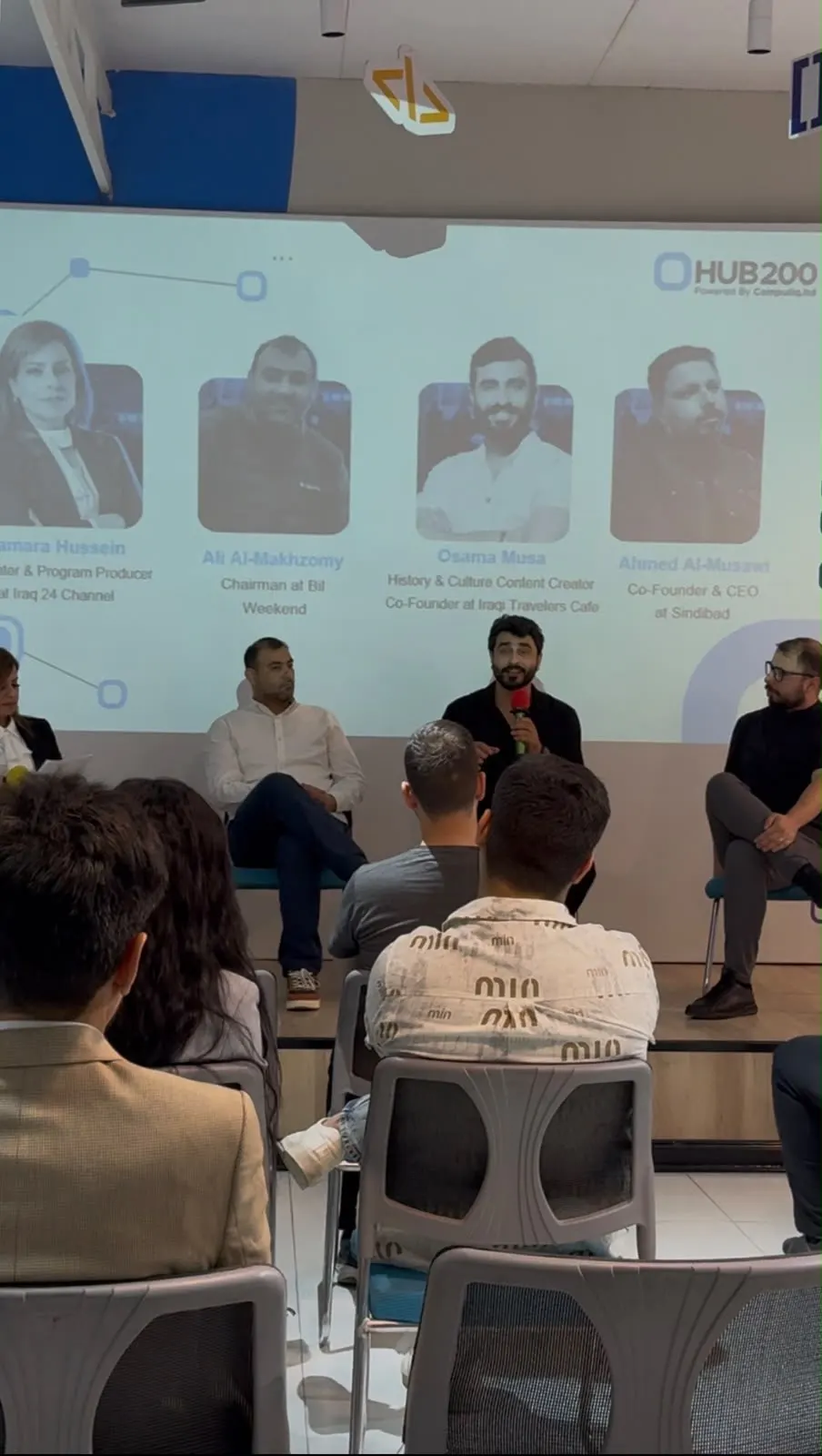 Osamah Mousa speaking on a panel at a community event